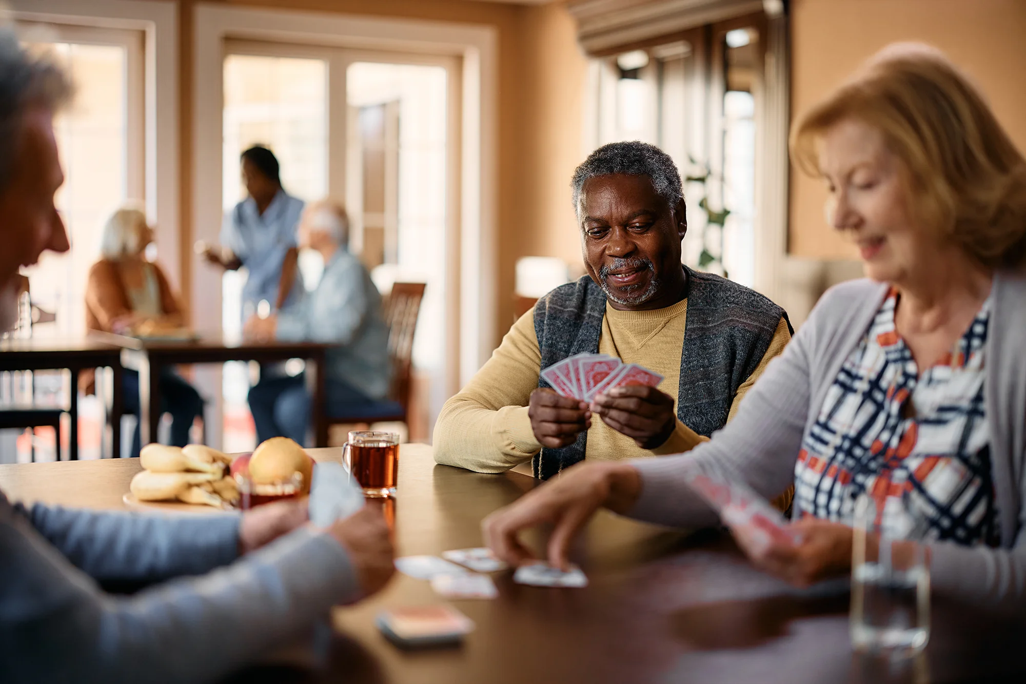 seniors playing cards in community