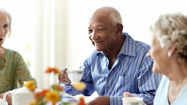 happy elderly man drinking beverage