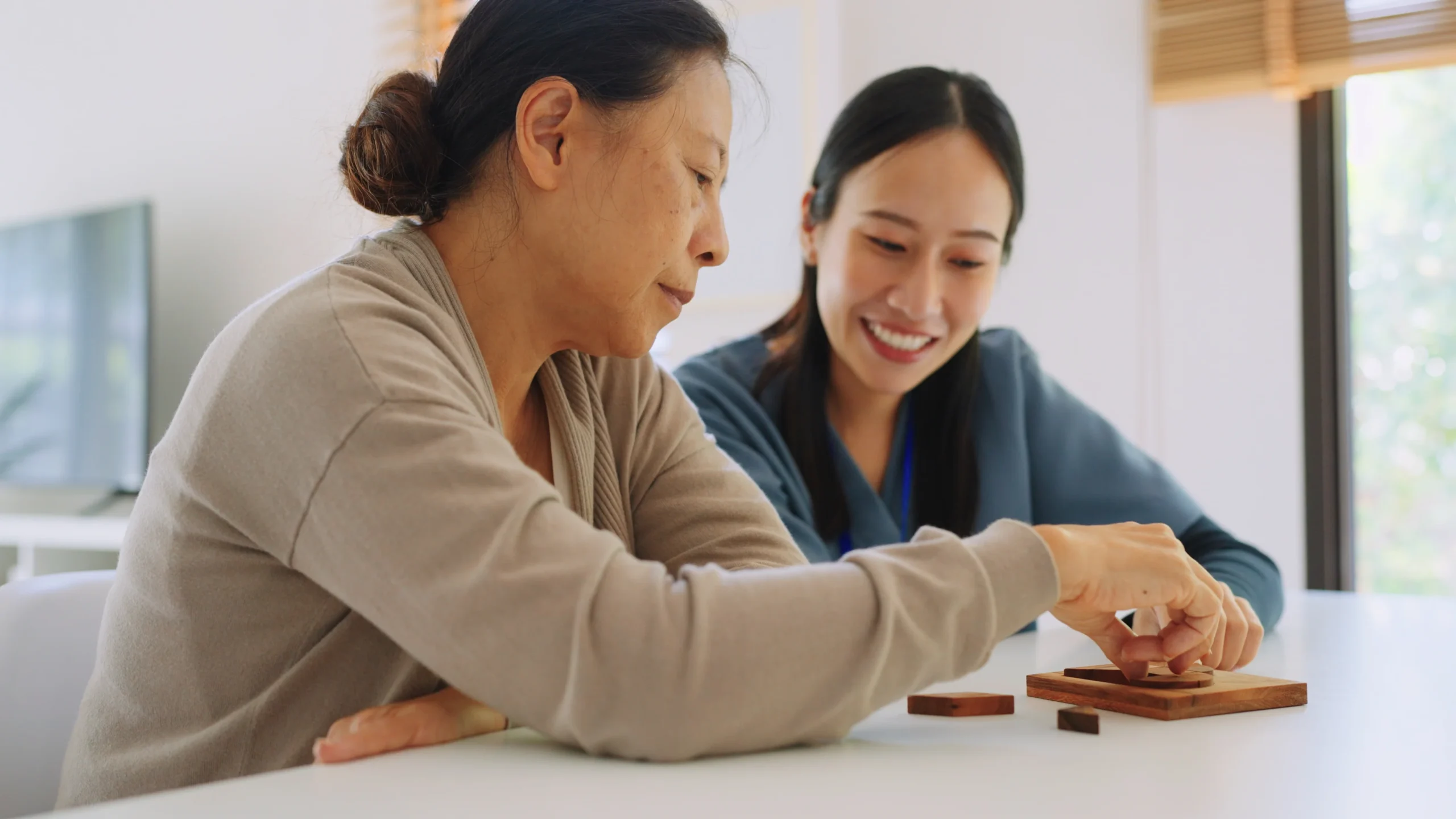 senior woman and caretaker playing game